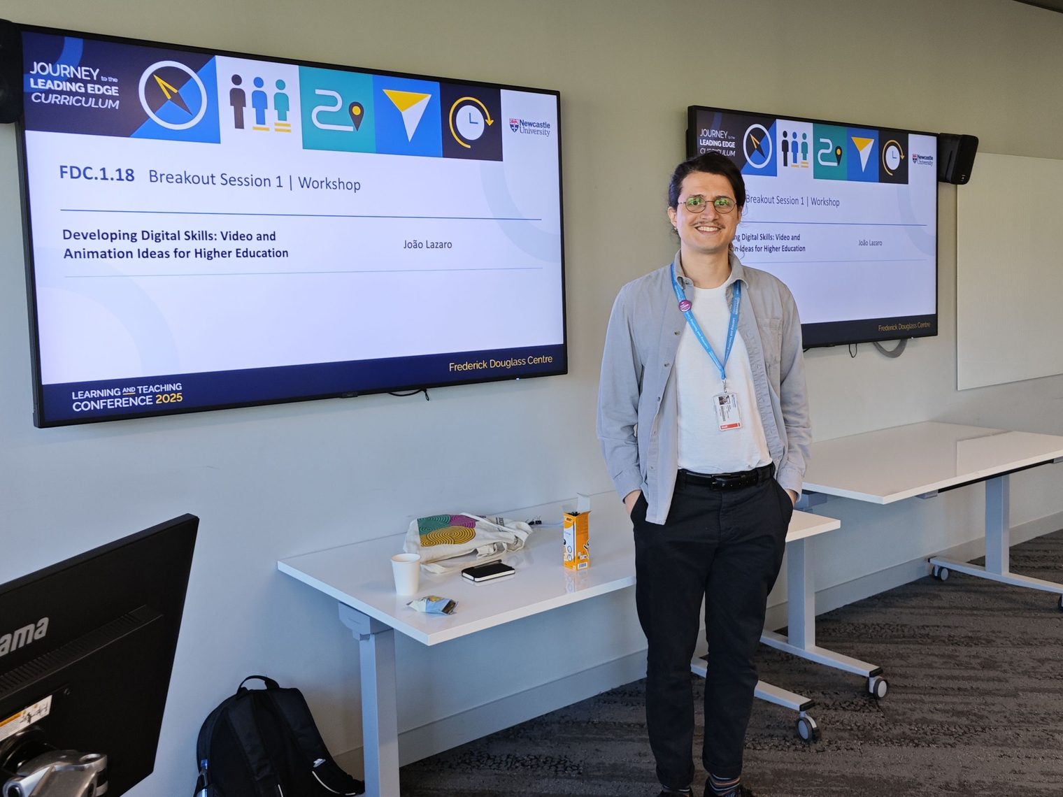 João Lazaro in the room before his workshop at Newcastle University's Learning and Teaching Conference 2025, the session title "Developing Digital Skills: Video and Animation Ideas for Higher Education" on the screens